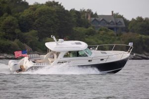 New Back Cove 34O boat on a lake with American flag